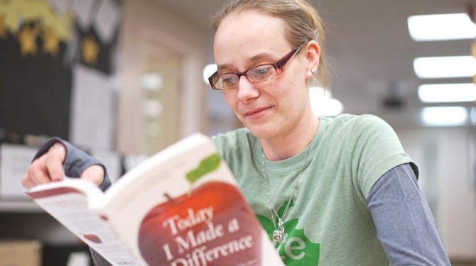 A female student reads a book at Seeds of Literacy.