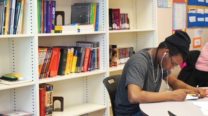 A GED student studies at Seeds of Literacy for his test