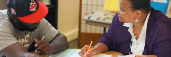 GED graduate Margo Hudson tutors a student at Seeds of Literacy on Cleveland's west side.