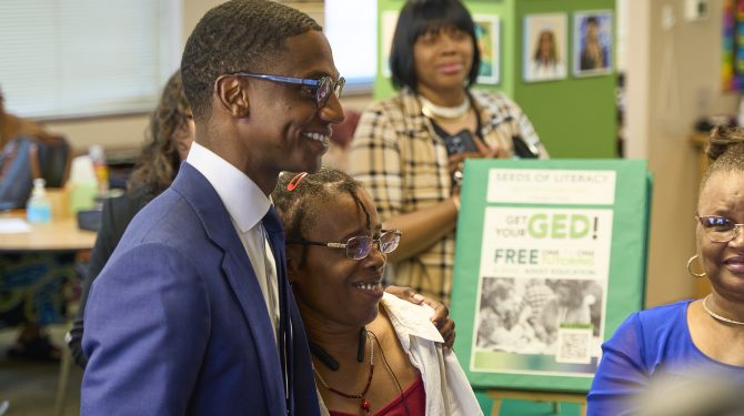 Cleveland Mayor Justin Bibb poses with a Seeds of Literacy student