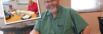 Tutor Bill Higgins sitting at a round table