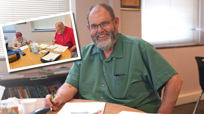 Tutor Bill Higgins sitting at a round table